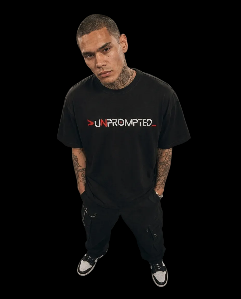 Person wearing a black t-shirt with 'UNPROMPTED' text on a dark background
